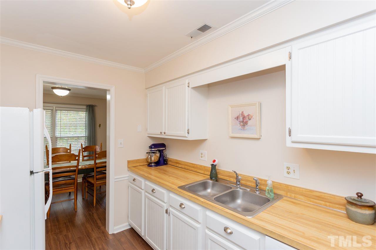 210 Bracken Court Raleigh, NC 27615 - Photo 11 of 26 a kitchen that has a sink and a stove in it