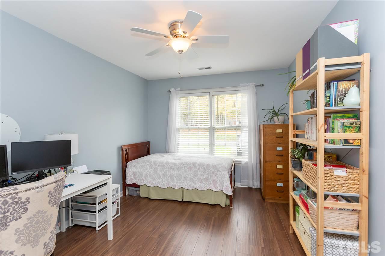 210 Bracken Court Raleigh, NC 27615 - Photo 13 of 26 a bedroom with furniture and a window