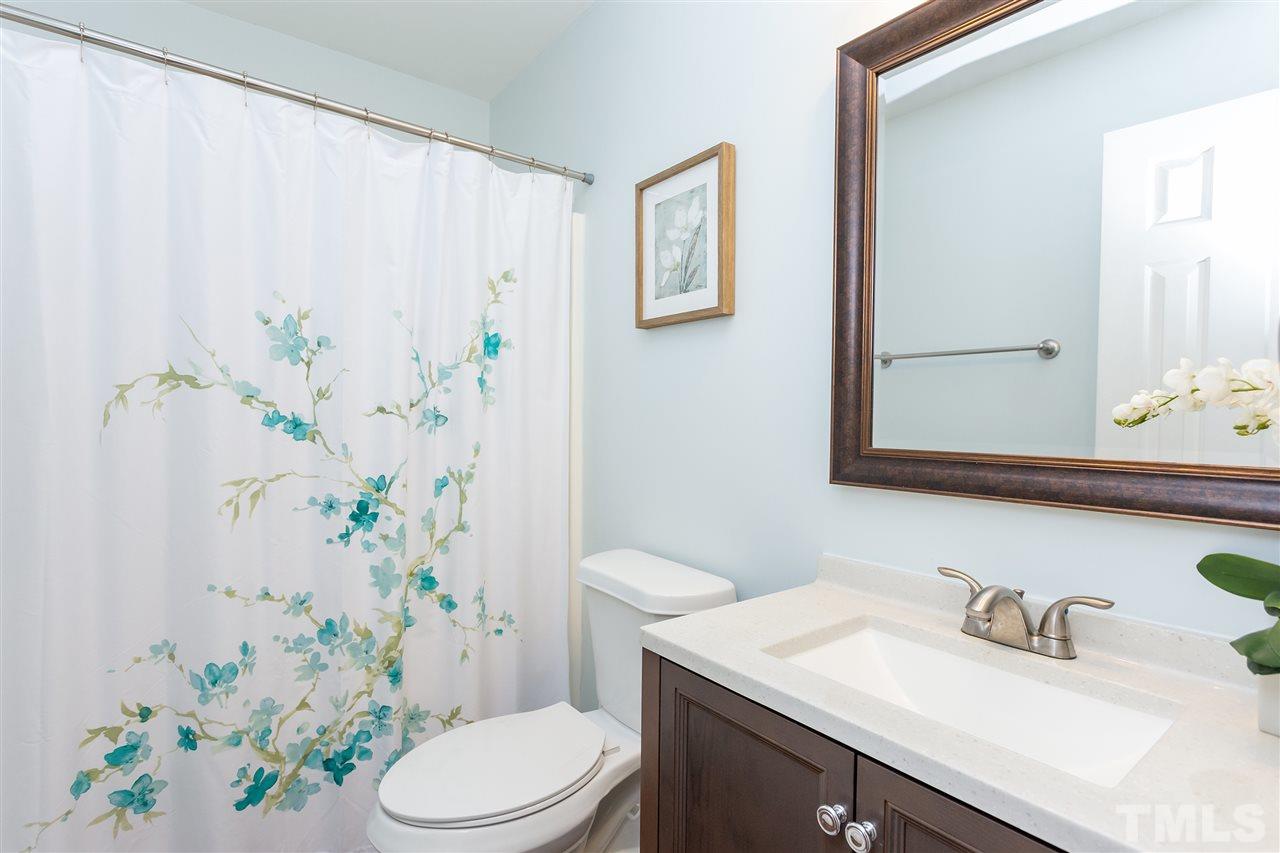 210 Bracken Court Raleigh, NC 27615 - Photo 15 of 26 a bathroom with a sink a toilet and shower curtain