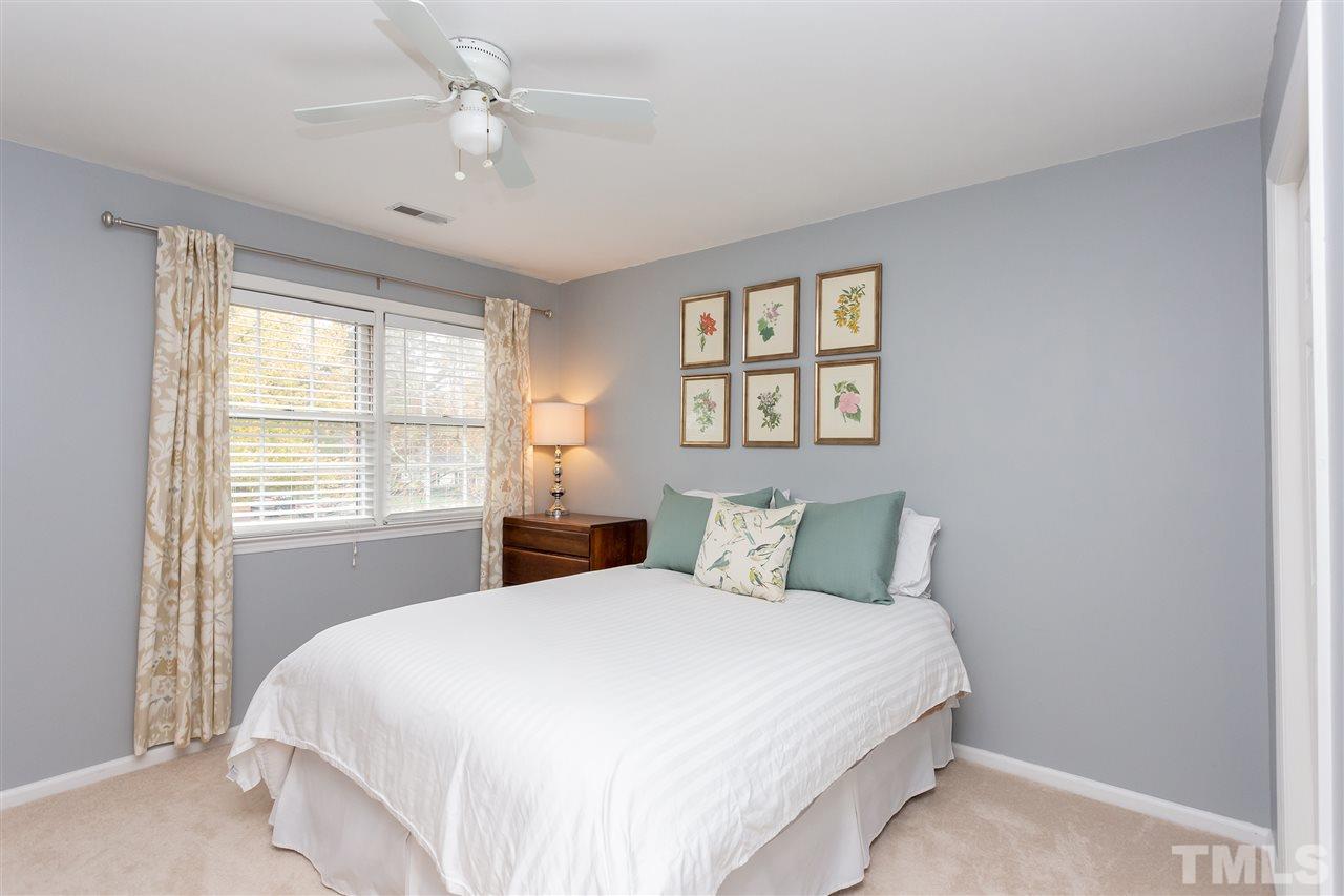 210 Bracken Court Raleigh, NC 27615 - Photo 16 of 26 a bedroom with a large bed and a window