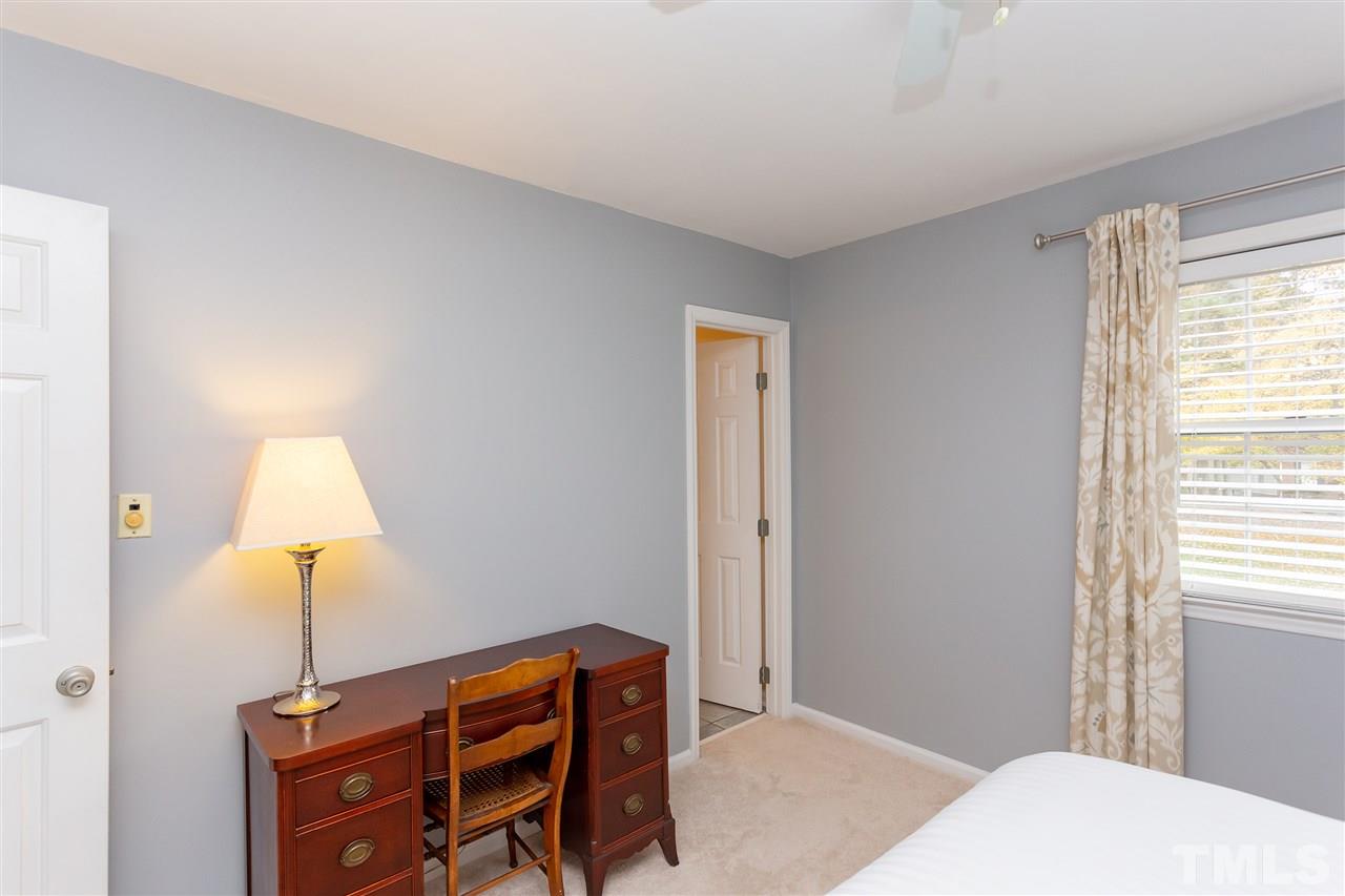 210 Bracken Court Raleigh, NC 27615 - Photo 17 of 26 a bedroom with a bed and a desk