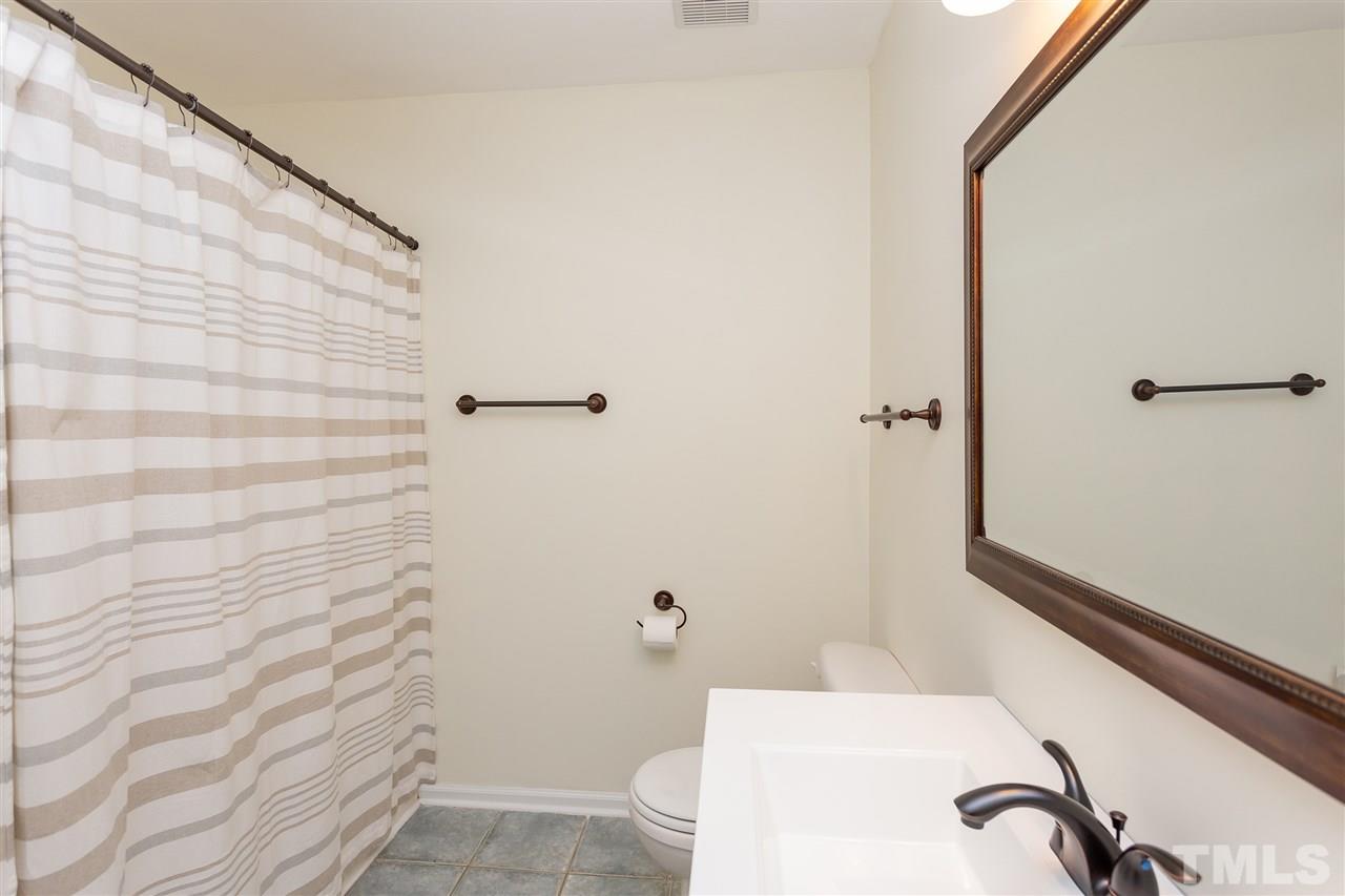 210 Bracken Court Raleigh, NC 27615 - Photo 19 of 26 a bathroom with a sink and shower