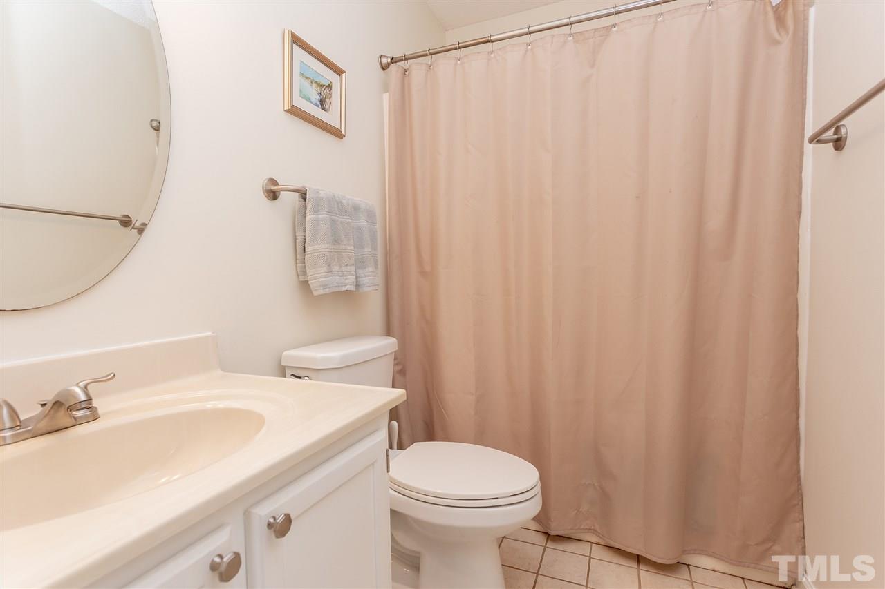 210 Bracken Court Raleigh, NC 27615 - Photo 23 of 26 a bathroom with a sink a toilet and shower curtain