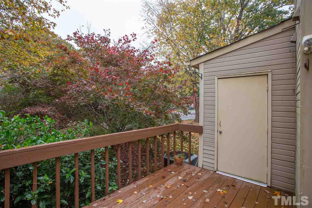 210 Bracken Court Raleigh, NC 27615 - Photo 24 of 26 a balcony with wooden floor and fence