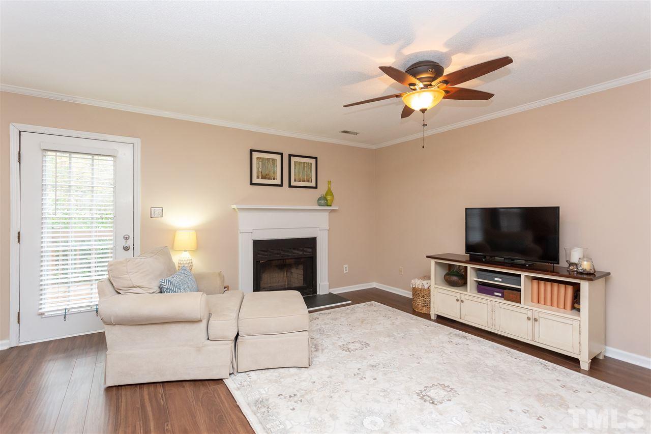 210 Bracken Court Raleigh, NC 27615 - Photo 5 of 26 a living room with furniture and a flat screen tv