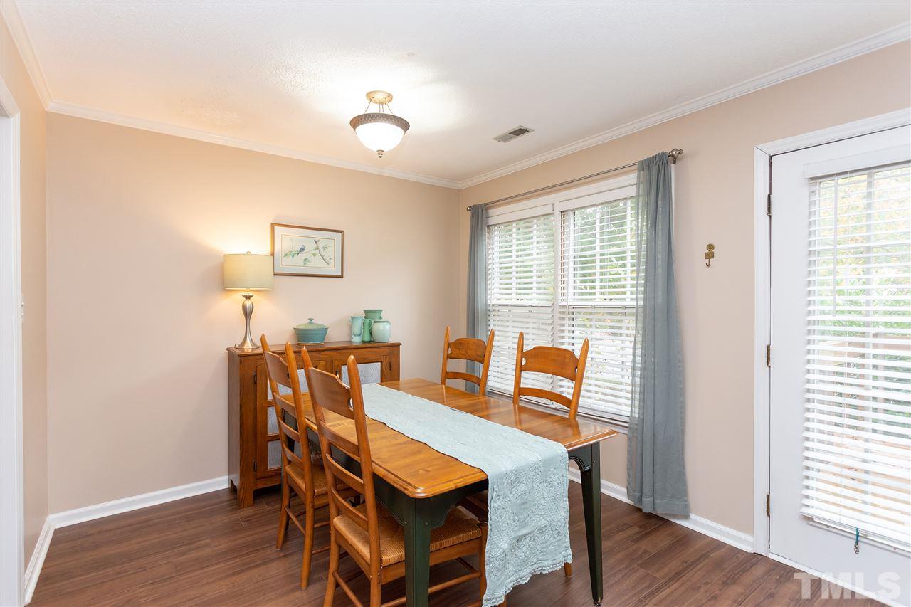210 Bracken Court Raleigh, NC 27615 - Photo 8 of 26 a dining room with furniture and wooden floor
