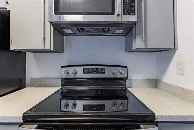a kitchen with stainless steel appliances granite countertop a sink and stove