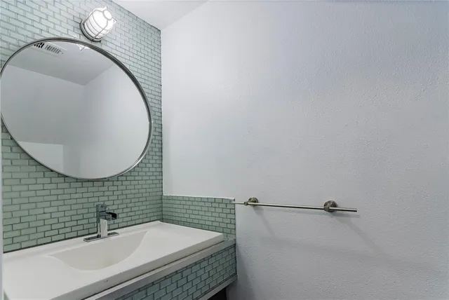 a bathroom with a double vanity sink and mirror