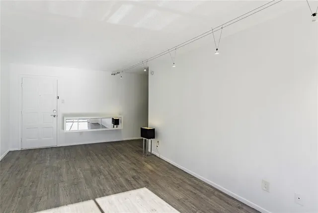 an empty room with wooden floor