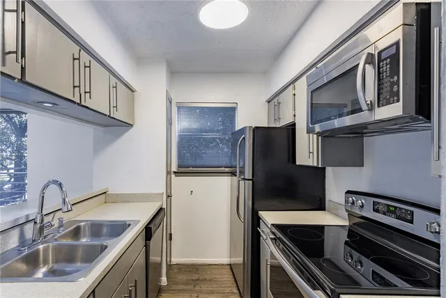 a kitchen with a sink and a window