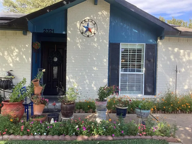 a front view of a house with potted plants