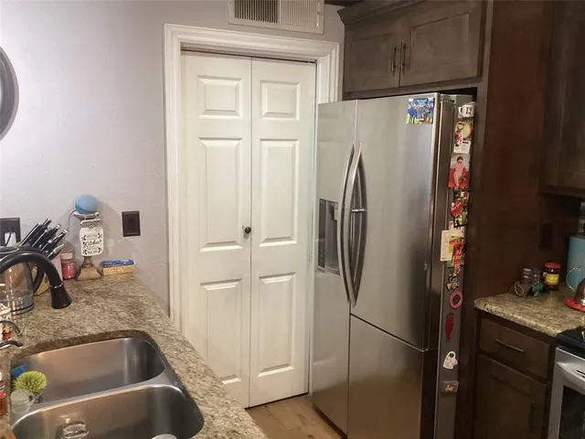 a bathroom with a sink and a refrigerator