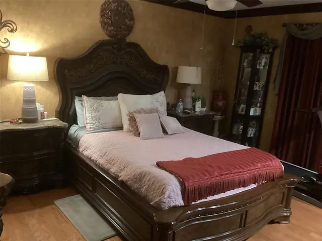 a bed sitting in a bedroom next to a lamp