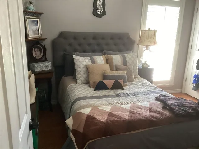 a bed sitting in a bedroom next to a window