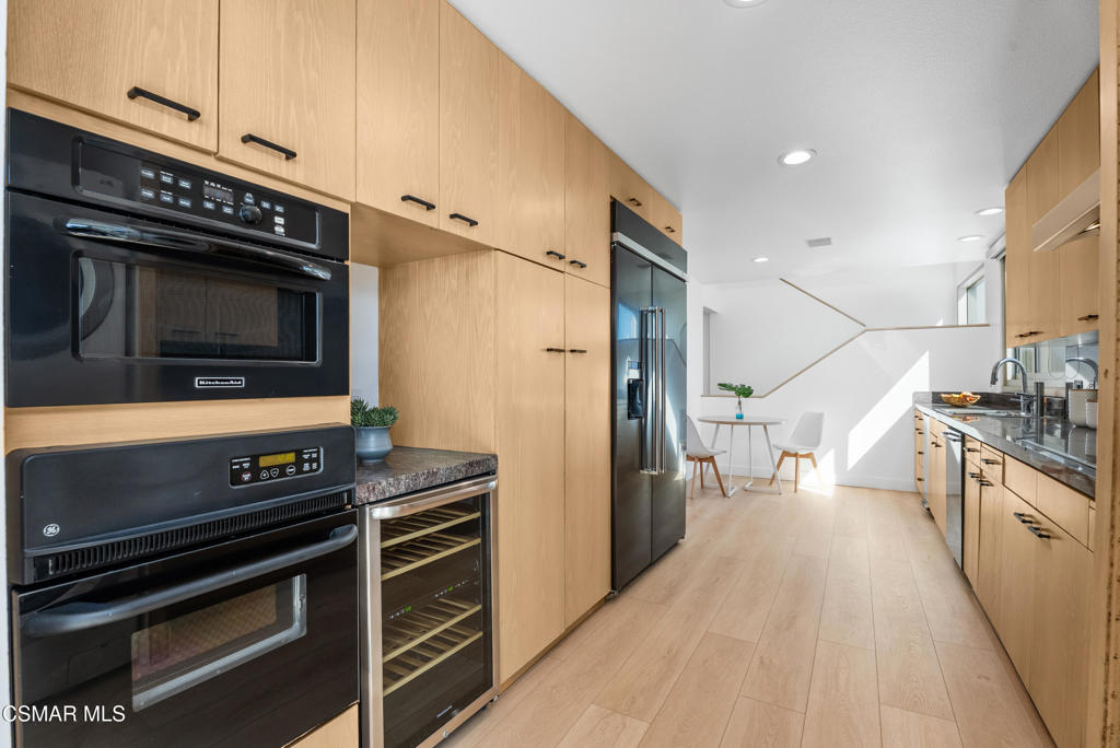 4 Jib Street, Unit 13 Marina del Rey, CA 90292 - Photo 14 of 53 a kitchen with stainless steel appliances a stove a microwave and a refrigerator