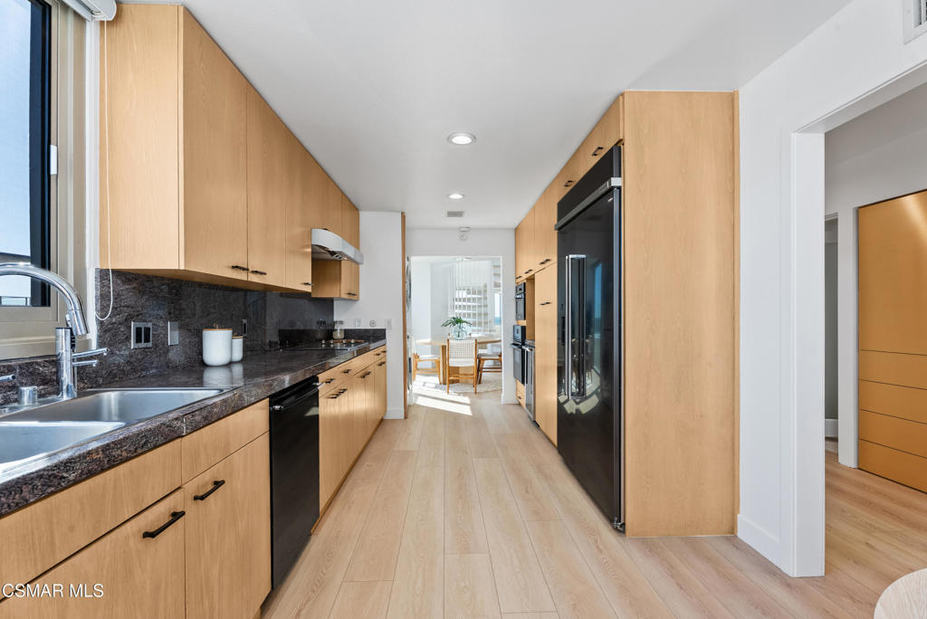 4 Jib Street, Unit 13 Marina del Rey, CA 90292 - Photo 16 of 53 a large kitchen with stainless steel appliances granite countertop a refrigerator a stove and a sink