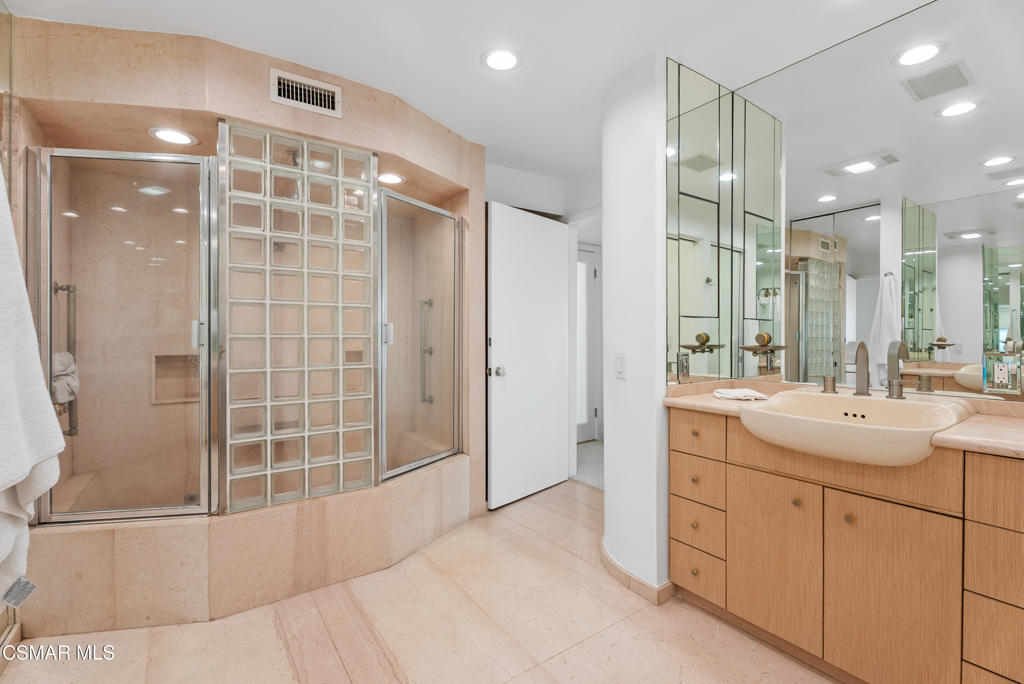 4 Jib Street, Unit 13 Marina del Rey, CA 90292 - Photo 22 of 53 a bathroom with a shower sink and mirror