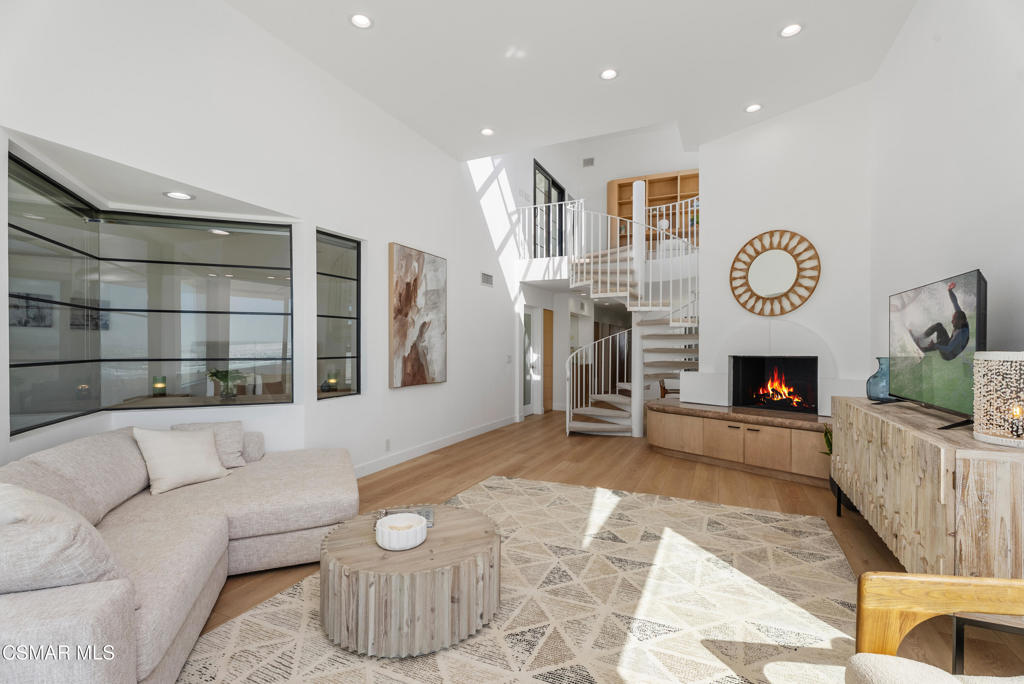 4 Jib Street, Unit 13 Marina del Rey, CA 90292 - Photo 28 of 53 a living room with furniture a fireplace and a flat screen tv