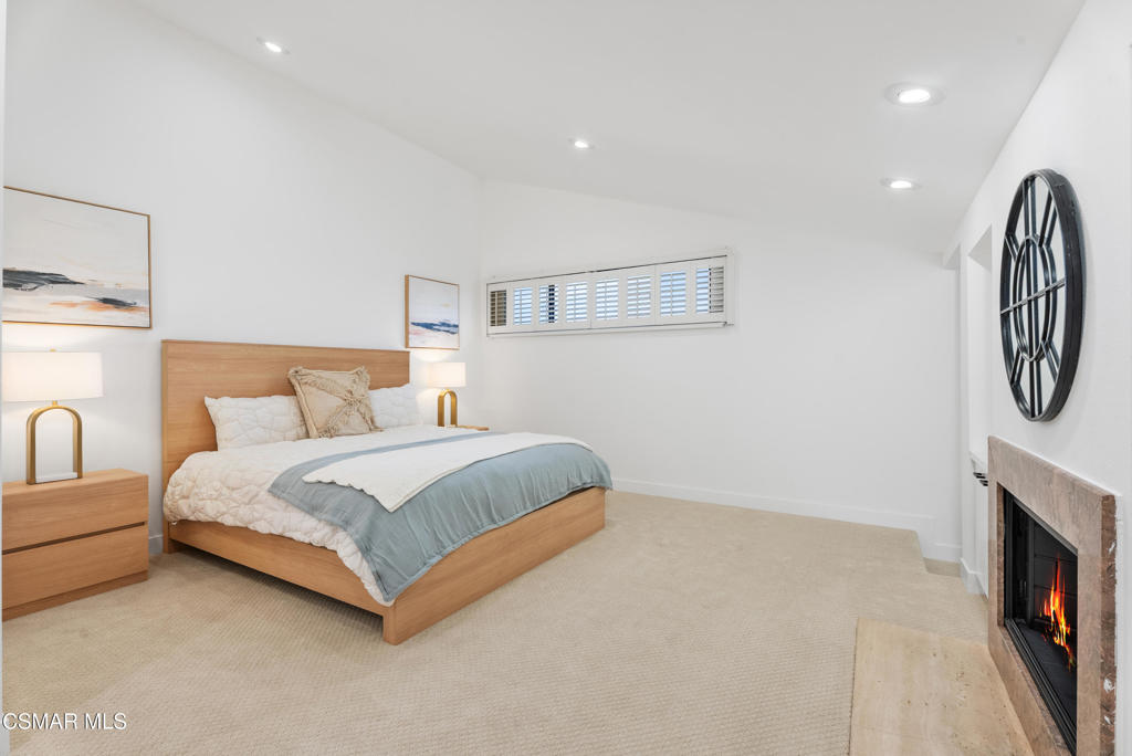 4 Jib Street, Unit 13 Marina del Rey, CA 90292 - Photo 34 of 53 a bedroom with bed and a fireplace