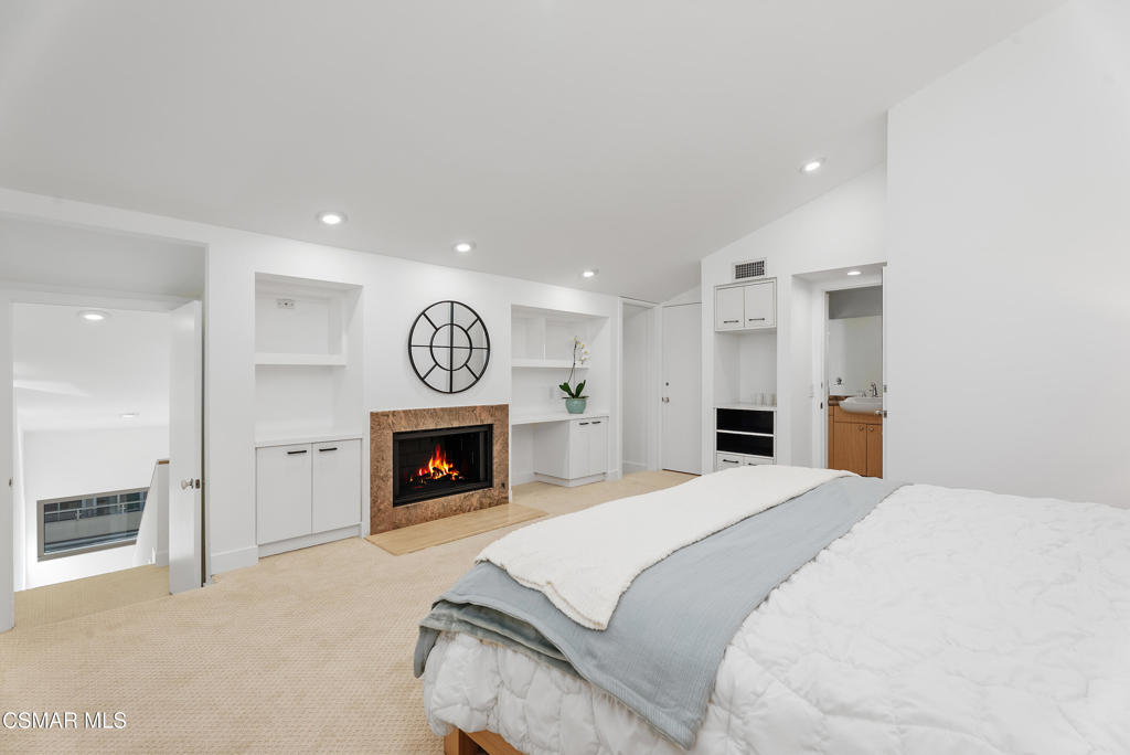 4 Jib Street, Unit 13 Marina del Rey, CA 90292 - Photo 35 of 53 a spacious bedroom with a bed and a fireplace