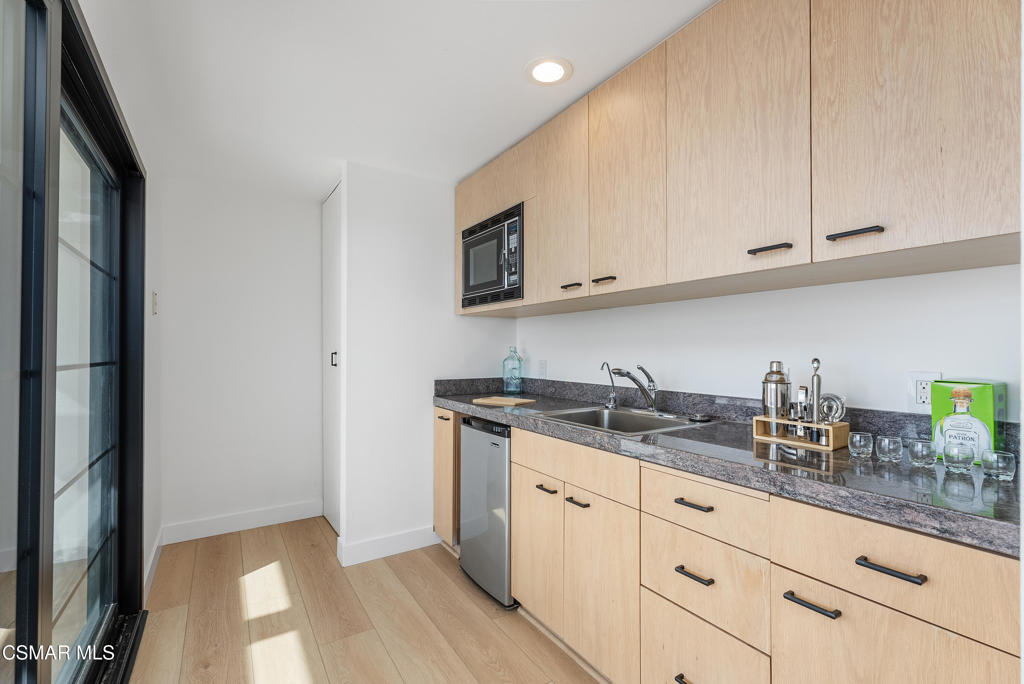 4 Jib Street, Unit 13 Marina del Rey, CA 90292 - Photo 39 of 53 a kitchen with granite countertop white cabinets and a sink