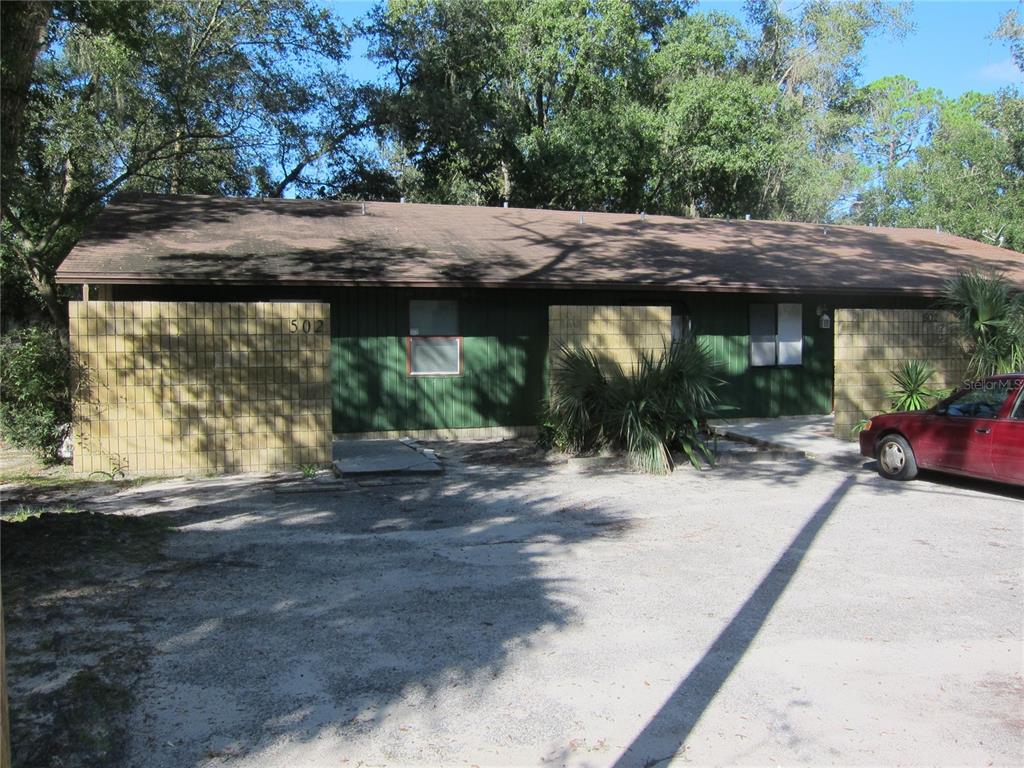 502 Southwest 68th Terrace Gainesville, FL 32607 - Photo 1 of 1 a backyard of a house with yard and outdoor seating