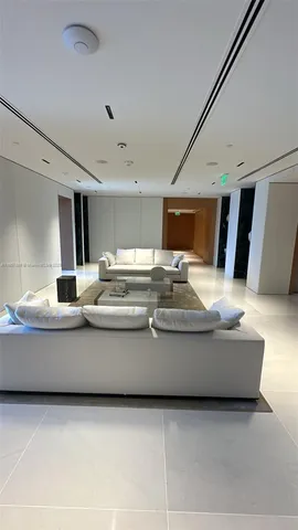 a living room with stainless steel appliances kitchen island granite countertop furniture and a couch