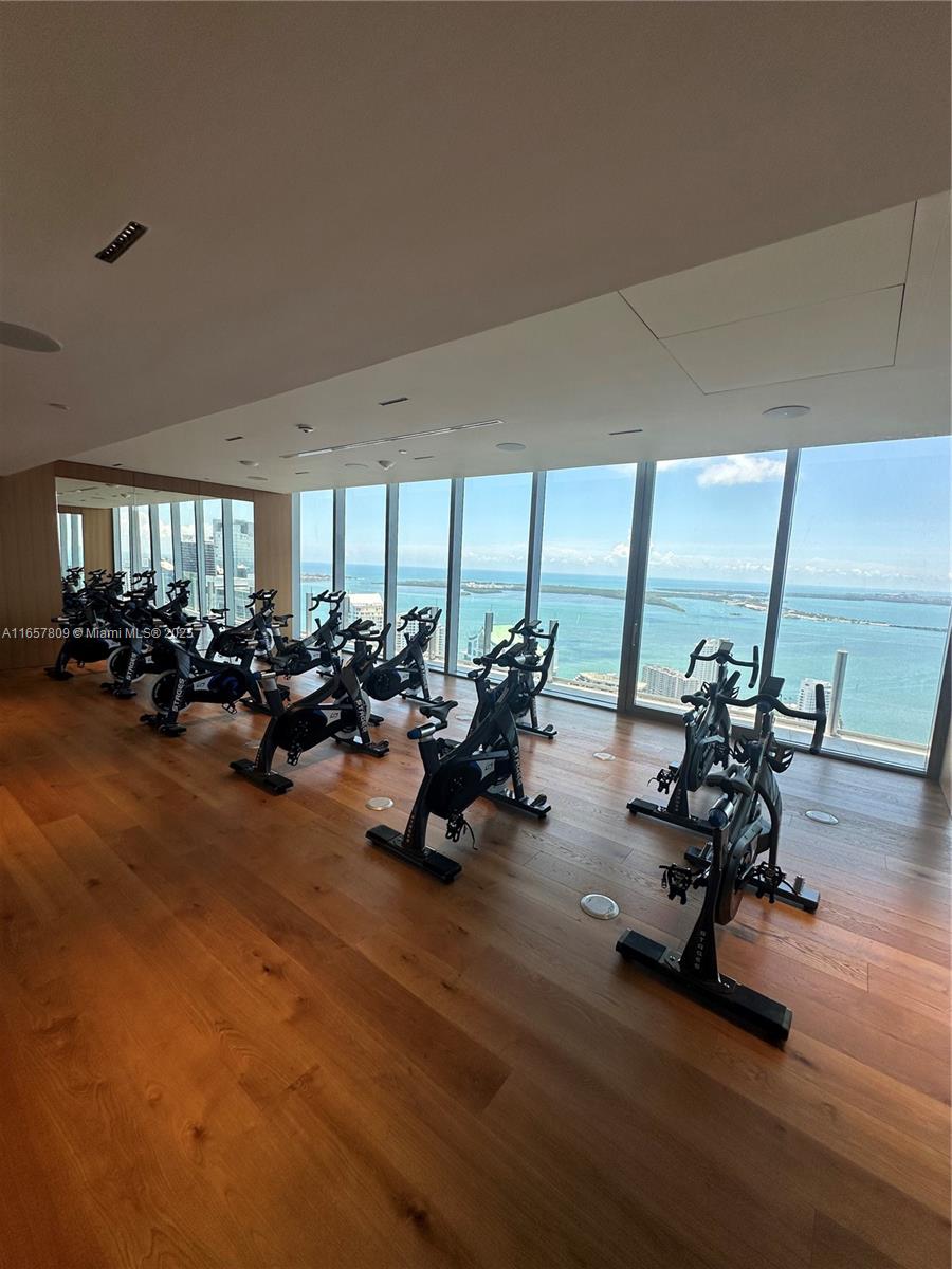 300 Biscayne Blvd Way, Unit 1909 Miami, FL 33131 - Photo 12 of 42 a view of a room with gym equipment and large windows