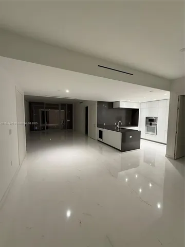 a kitchen with stainless steel appliances kitchen island sink and cabinets