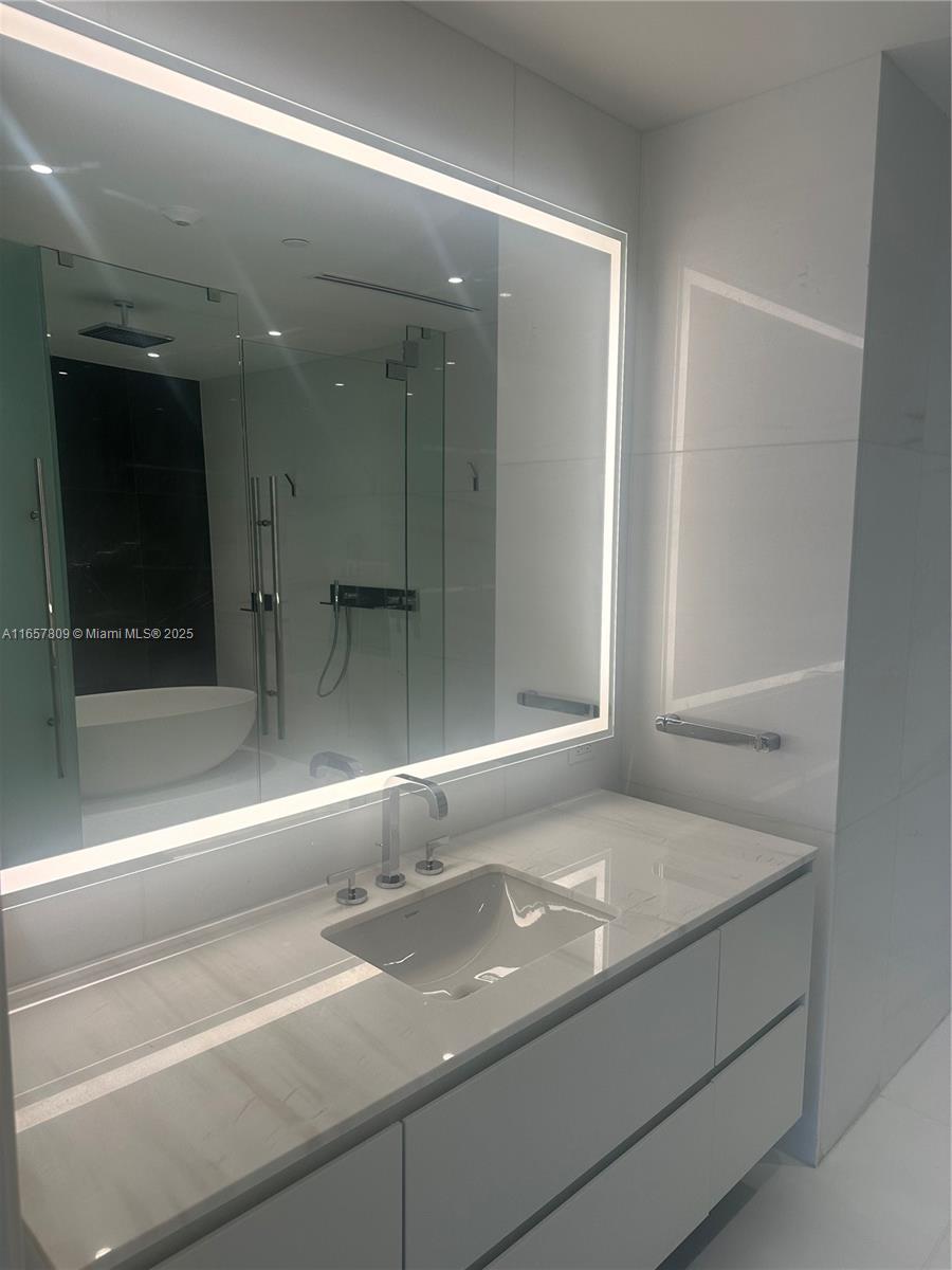 300 Biscayne Blvd Way, Unit 1909 Miami, FL 33131 - Photo 26 of 42 a view of kitchen with granite countertop cabinets and sink