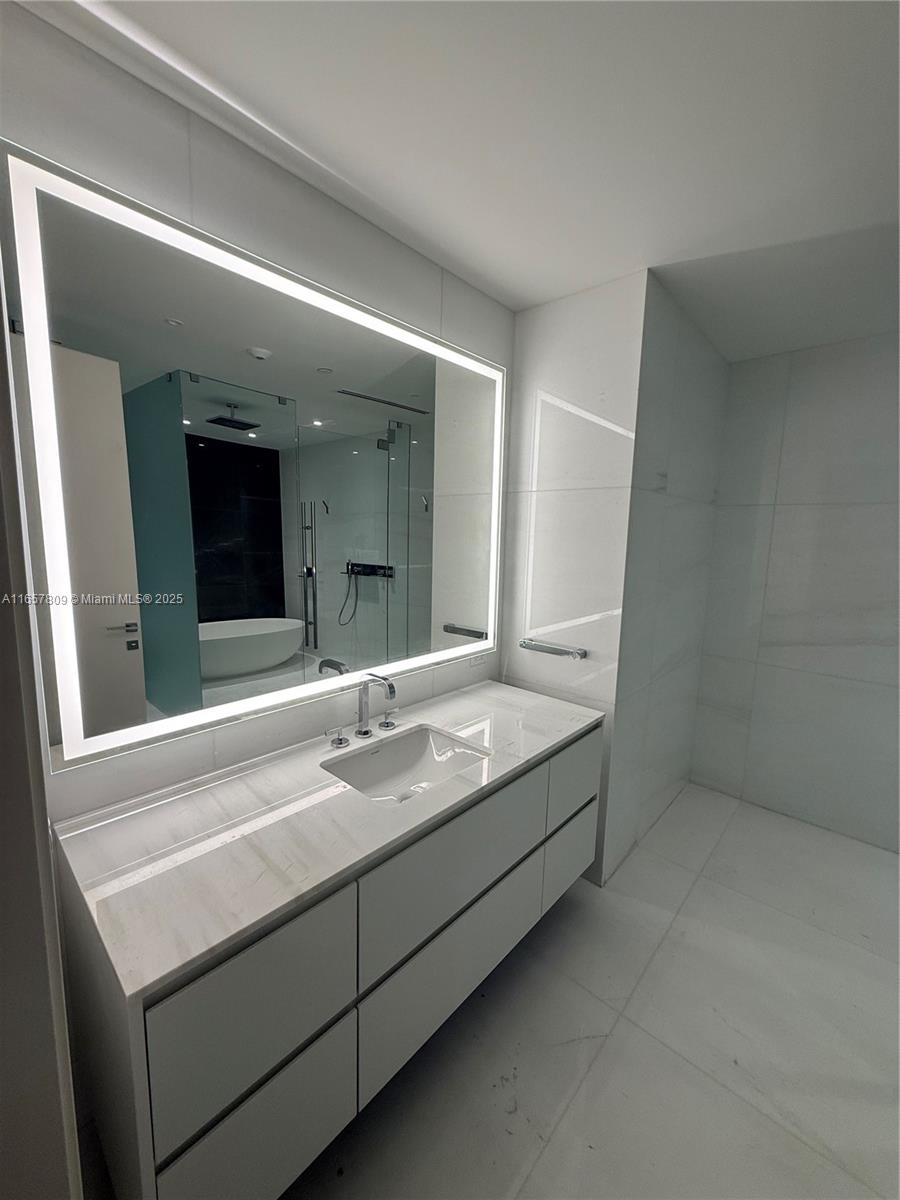 300 Biscayne Blvd Way, Unit 1909 Miami, FL 33131 - Photo 29 of 42 a bathroom with a sink and a mirror
