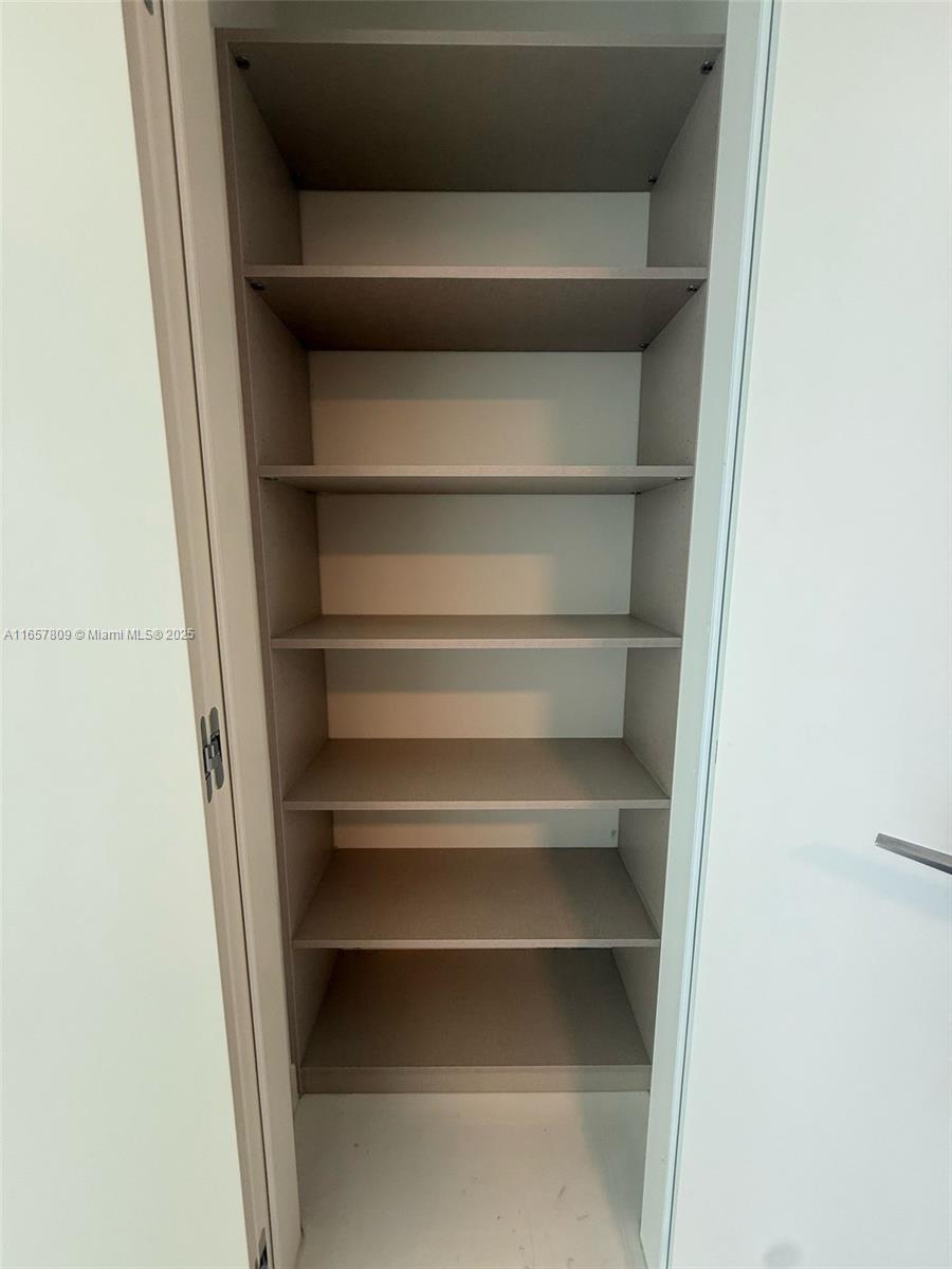300 Biscayne Blvd Way, Unit 1909 Miami, FL 33131 - Photo 39 of 42 a view of walk in closet with empty racks