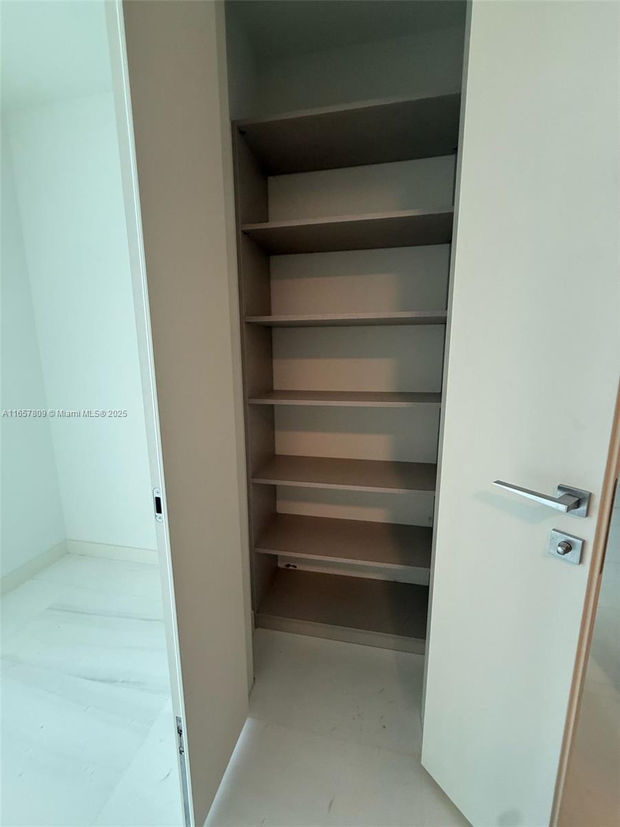 300 Biscayne Blvd Way, Unit 1909 Miami, FL 33131 - Photo 40 of 42 a view of walk in closet with empty racks