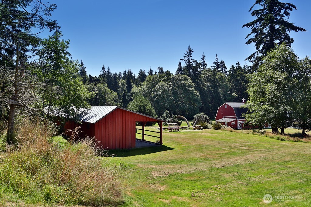 364 Gramayre Road Coupeville, WA 98239 - Photo 16 of 38 a backyard of a house with table and chairs