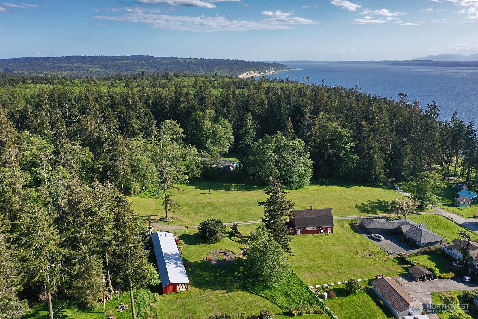 364 Gramayre Road Coupeville, WA 98239 - Photo 32 of 38 an aerial view of green landscape with trees houses and mountain view