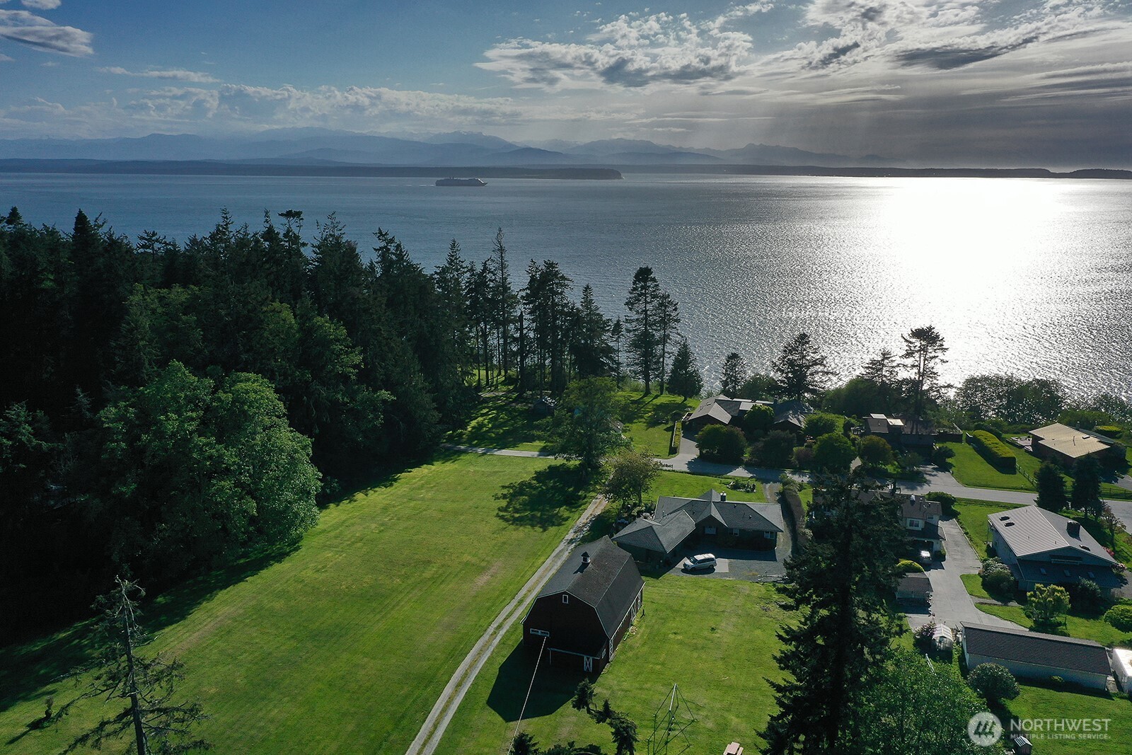 364 Gramayre Road Coupeville, WA 98239 - Photo 7 of 38 a view of a lake with a yard