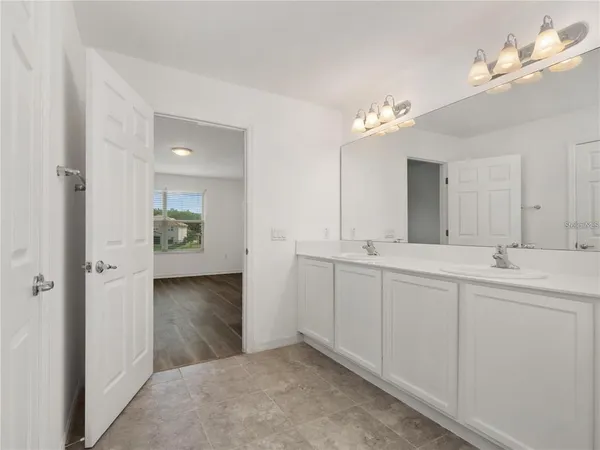 a bathroom with a double vanity sink and a mirror