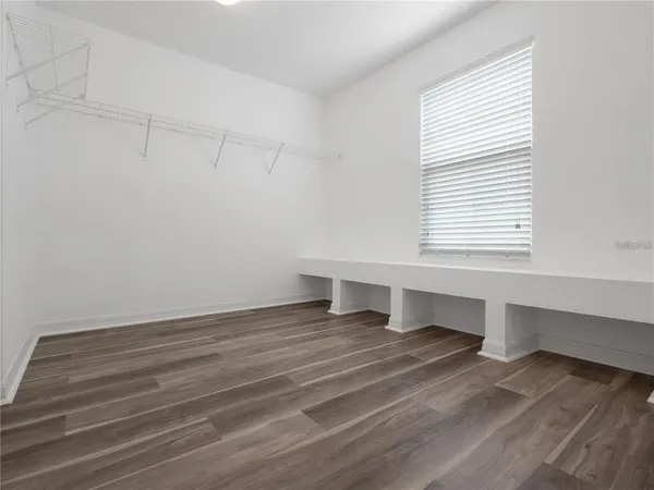 wooden floor in an empty room with a window