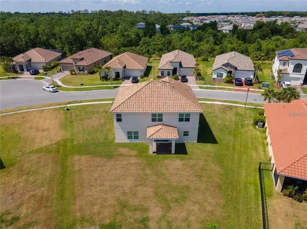 a aerial view of a house with swimming pool and green space