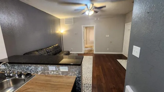 a living room with furniture and a rug