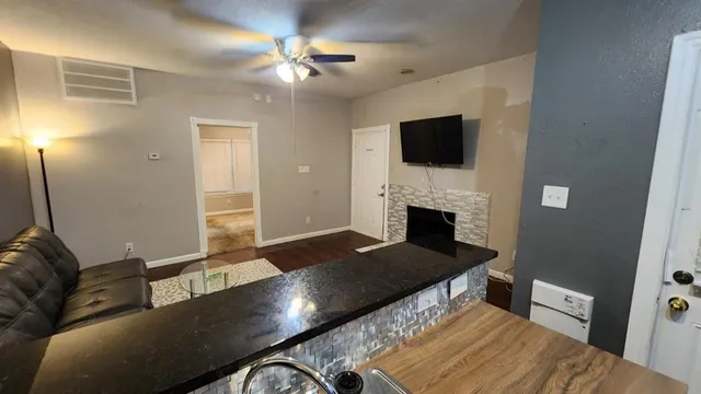 a living room with furniture and a fireplace