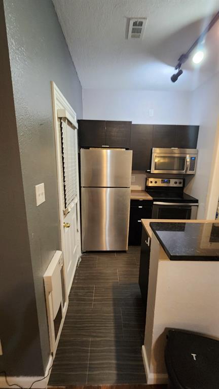 4101 Esters Road, Unit 111 Irving, TX 75038 - Photo 15 of 34 a kitchen with a refrigerator and a stove
