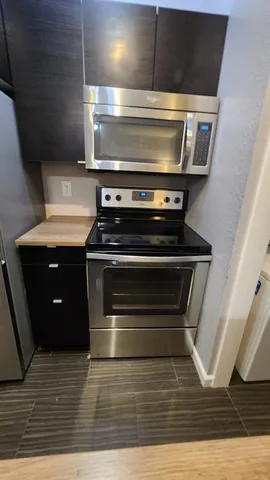 a stove top oven sitting inside of a kitchen