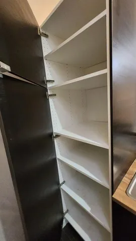 a view of walk in closet with empty racks