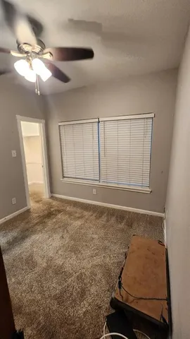 a view of kitchen with refrigerator and cabinets