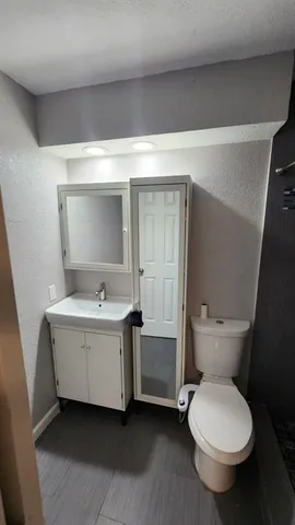 a bathroom with a toilet and a shower