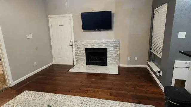 a living room with a fireplace and a flat screen tv