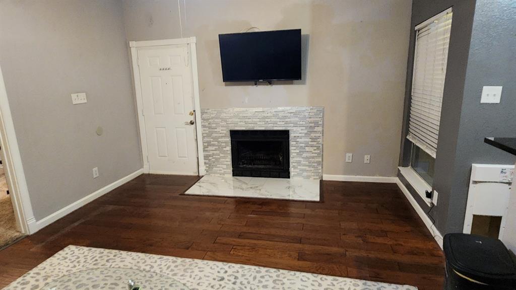 4101 Esters Road, Unit 111 Irving, TX 75038 - Photo 5 of 34 a living room with a fireplace and a flat screen tv