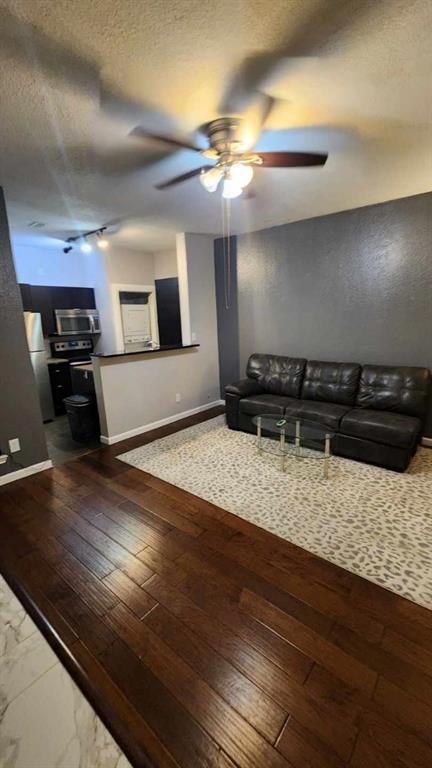 4101 Esters Road, Unit 111 Irving, TX 75038 - Photo 6 of 34 a kitchen with kitchen island granite countertop a stove and a wooden floor