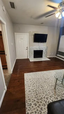 a view of a livingroom with an empty space and a fireplace
